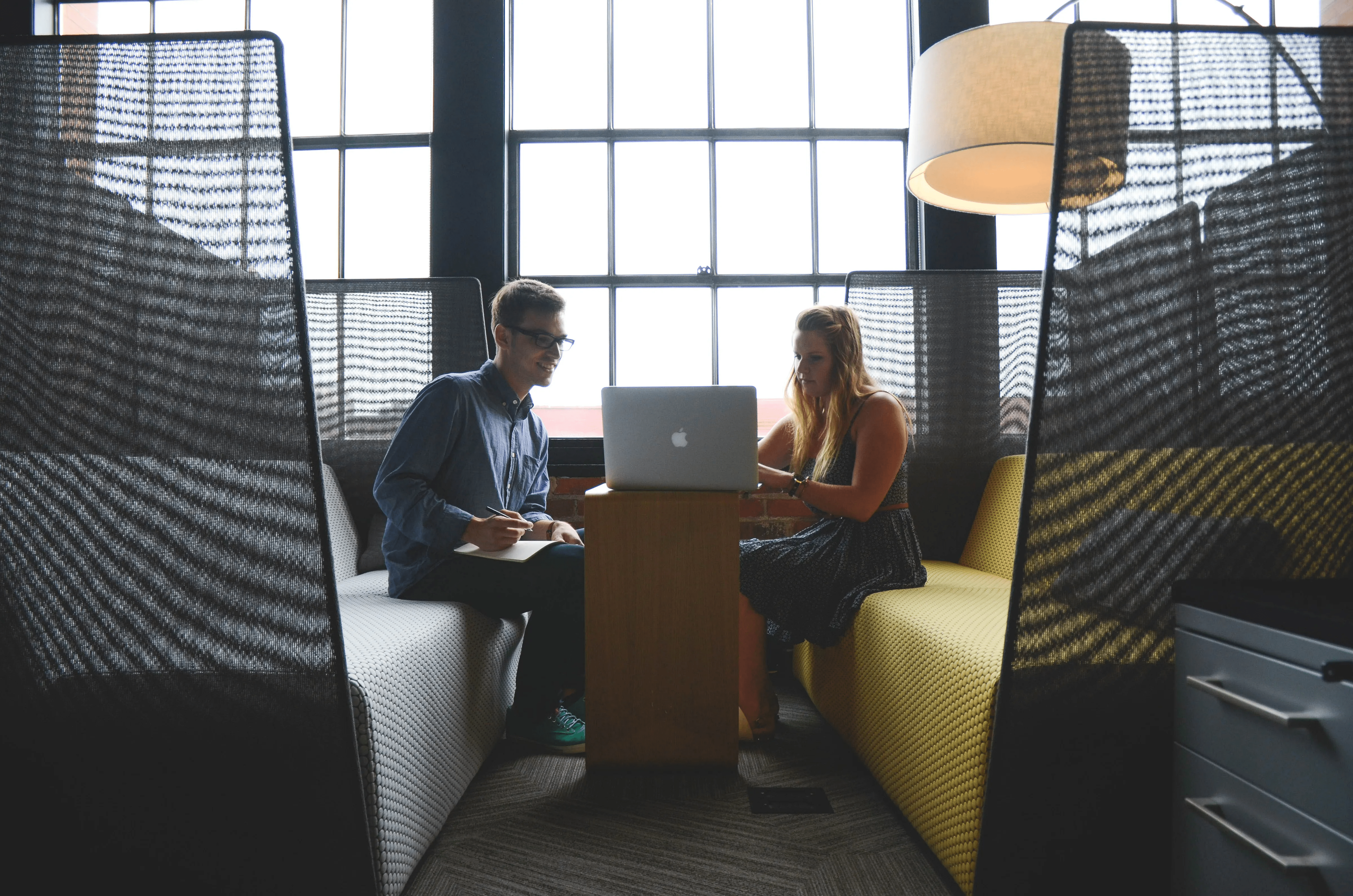 Two people looking at a laptop.